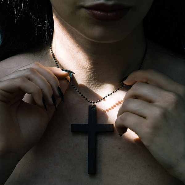 Repent Later cross necklace worn