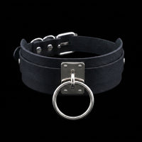 Black O-ring leather collar centered on pure black background