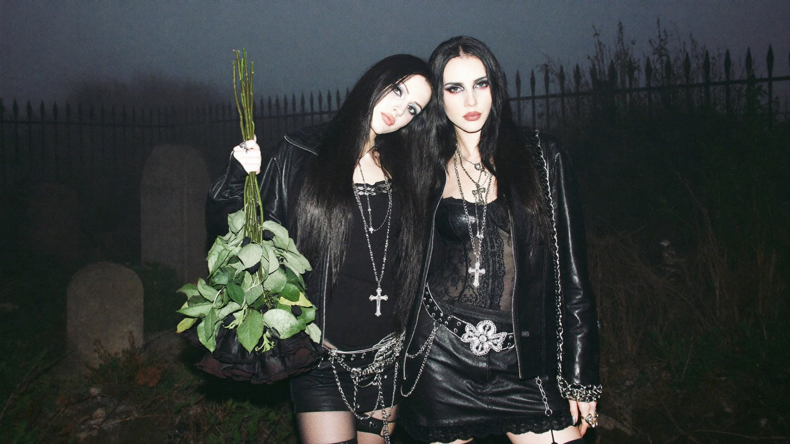 Two models in a foggy cemetery, flash-lit, stacked silver jewelry